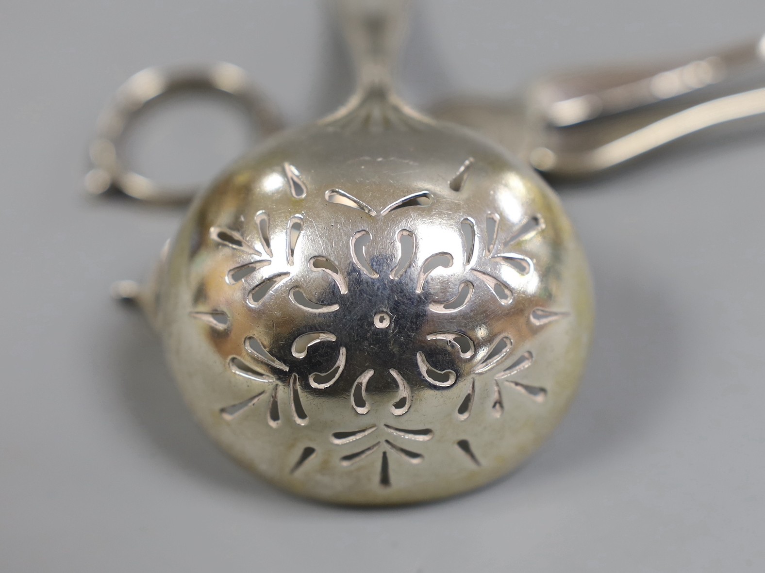 A pair of George III silver sugar nips, George Smith III, London, circa 1780, 11.6cm and a sterling sifter spoon, 2.2oz.